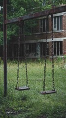 Eerie Abandoned Schoolyard with Overgrown Grass and Rusty Swings