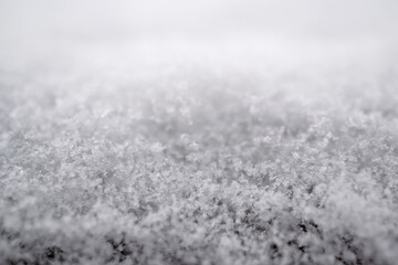 close-up photograph of a snow texture, individual flakes are visible, macro photography taken from different angles and differentiated focus
