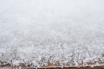 close-up photograph of a snow texture, individual flakes are visible, macro photography taken from different angles and differentiated focus
