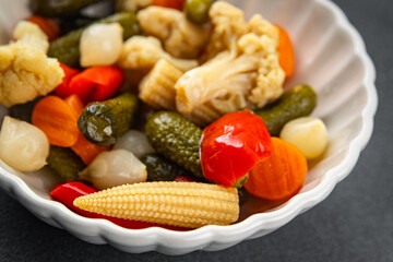 Marinated vegetables mix salad cucumber, corn, pepper, carrot, cauliflower, onion fresh tasty food dish gourmet food background on the table rustic food top view copy space vegetarian and vegan food