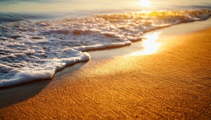 sandy beach lit by sun sea water washes over closeup detail abstract shallow depth of field tropical vacation background