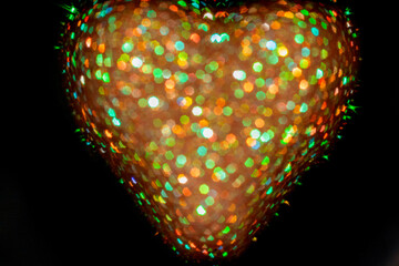 Colorful heart-shaped bokeh in a dark background creating vibrant light patterns