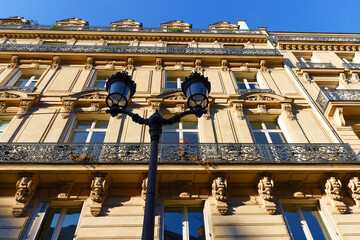 Exterior architecture of Traditional French house with typical balconies and windows in Paris....