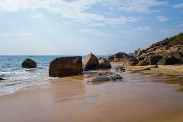 Rocks on Samudra Beach in Kovalam in Asia, India, Kerala, Kovalam, in summer, on a sunny day.