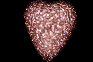 Heart-shaped holiday lights with glowing bokeh effect on dark background