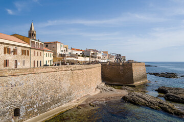 The fortifications at the seaside in Alghero in Europe, Italy, Sardinia, Alghero, in summer, on a sunny day.