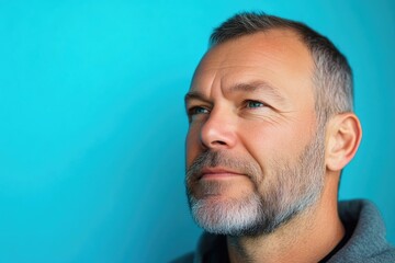 Obraz premium Middle-aged man deep in thought, close-up portrait