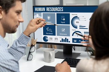 Human resources management software on computer screen helping human resources employee to manage...