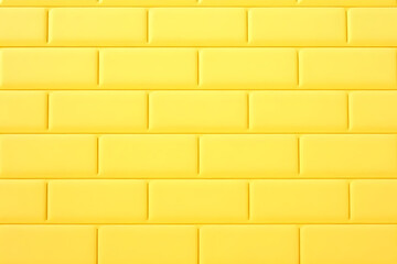 Obraz premium Bright yellow wall tiles create vibrant and cheerful atmosphere, perfect for modern interiors or playful spaces. uniform pattern adds touch of contemporary design
