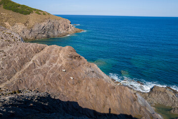 The cliffs in Argentiera in Europe, Italy, Sardinia, Argentiera, in summer, on a sunny day.