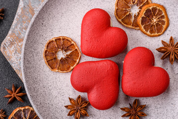 Red macaroons in the shape of a heart, sweets for the holiday of Valentine's Day