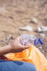 preteen, young child collecting plastics for the recovery of the environment. ecological education