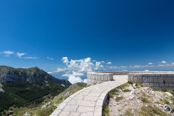 Fototapeta premium Lovcen National Park, a historic stone building perched atop a scenic mountain