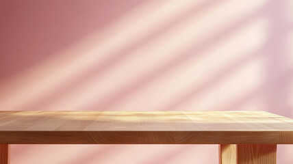 Wooden table against a pink wall with sunlight shadows.