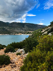 Fototapeta premium Scenic coastal view of rocky hills and calm water in a serene nature setting