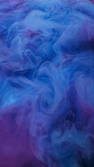 Ink explosion. Smoke cloud. Defocused blue purple color haze paint mist texture vapor liquid sparkle flow on abstract art background.
