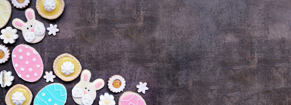 Poster easter or spring themed baking corner border with assorted cookies and sweet desserts. top view on a
