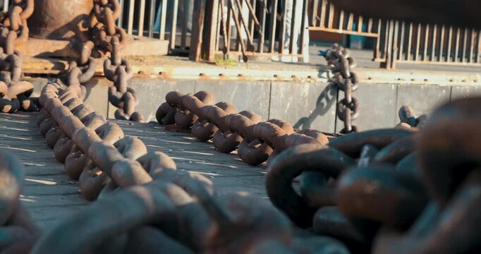 The detailed image of rusty and heavy iron chains reveals the traces of time and the industrial atmosphere. This scene symbolizes strength and durability, reflecting stories from the past.