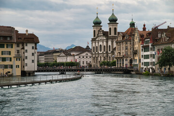 Center of Lucerne with the river Rees, the pedestrian bridge and the Jesuit church in the background.	