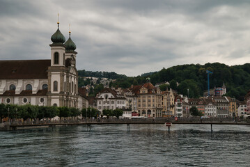 Center of Lucerne with the river Rees, the pedestrian bridge and the Jesuit church in the background.	