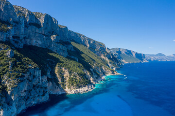 The cliffs around Cala Goloritze beach in Baunei in Europe, Italy, Sardinia, Baunei, in summer, on a sunny day.