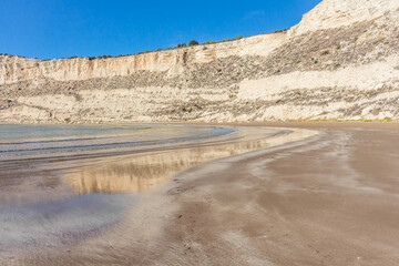Zapallo Bay Beach in Cyprus: Sandy Shore, Rocks in the Sea, White Cliff, Sunny Day