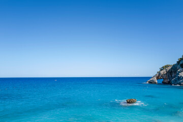 Naklejka premium The sea in front of Cala Goloritze beach in Baunei in Europe, Italy, Sardinia, Baunei, in summer, on a sunny day.