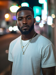 Fototapeta premium Young man posing in the city at night wearing necklaces