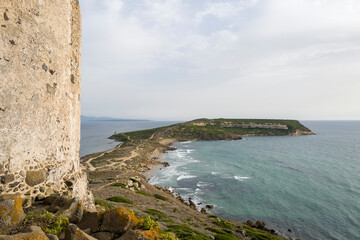 Capo San Marco and its watchtower in Europe, Italy, Sardinia, Cabras, in summer, on a sunny day.