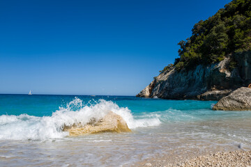 The rocks of Cala Goloritze beach in Baunei in Europe, Italy, Sardinia, Baunei, in summer, on a...