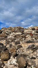 Stones with mortar and white clouds as background