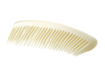 A delicate white comb resting gracefully against a soft, bright background isolated on transparent background