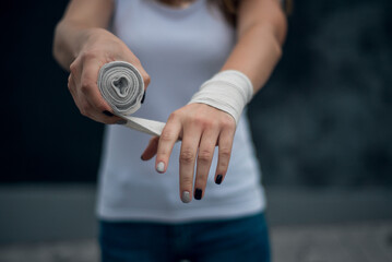 the athlete wraps hands with a sports bandage