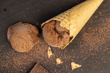 chocolate ice cream with chocolate chips on black slate