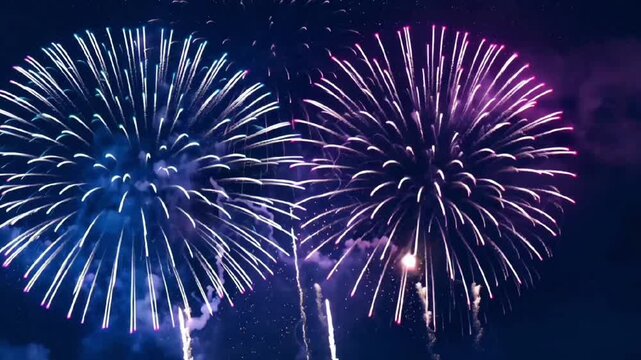 Beautiful colorful fireworks exploding in the night sky with bright sparkling lights, festive celebration, and holiday event background