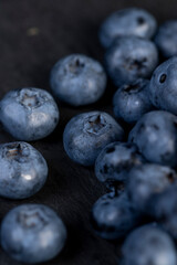 a pile of blueberries scattered on the board