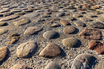 a part of the road made of cobblestones, an old-style pavement