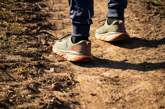 close up of crross country running feet, hoka one one shoes
