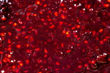 Crumpled sweet raspberries with added sugar