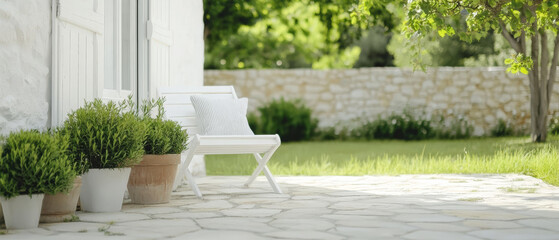 Serene outdoor setting with white furniture and lush greenery in a sunny garden