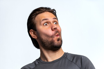 Fototapeta premium Young man emotional amazement portrait on white background
