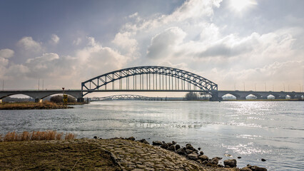 View of the old IJssel bridge also called Katerveer bridge, on a sunny winter day. The bridge crosses the river IJssel from the Hanseatic cities of Zwolle to Hattem, province of Overijssel.