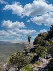 Hiker Standing on Mountain Peak with Breathtaking View