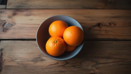 Bowl of Oranges on a Wooden Table