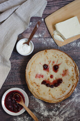 Kids pancakes with funny face for breakfast.  Funny Maslenitsa for children. Pancakes with butter,  sour cream and jam. 