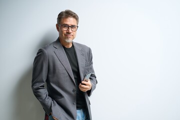 Middle age businessman in business casual using phone. Entrepreneur in jacket. Mid adult, mature age man, happy smiling. Portrait isolated on white.