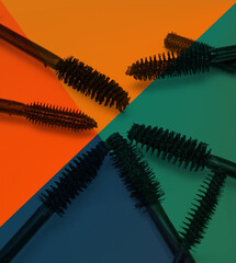 various mascara brushes on colorful background