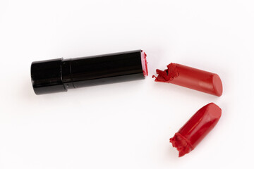 Fototapeta premium A Broken Red Lipstick on a White Background Highlighting the Challenges of Beauty Products and Everyday Makeup Essentials for Fashion Enthusiasts and Professionals