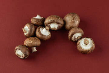 Delicious Brown Mushrooms Perfectly Arranged on a Rich Red Background for Culinary Inspirations and Recipe Ideas