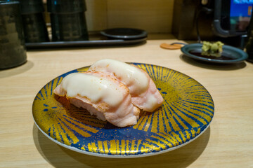 Salmon sushi cooked in Osaka in Asia, Japan, Kansai, Osaka, in summer, on a sunny day.